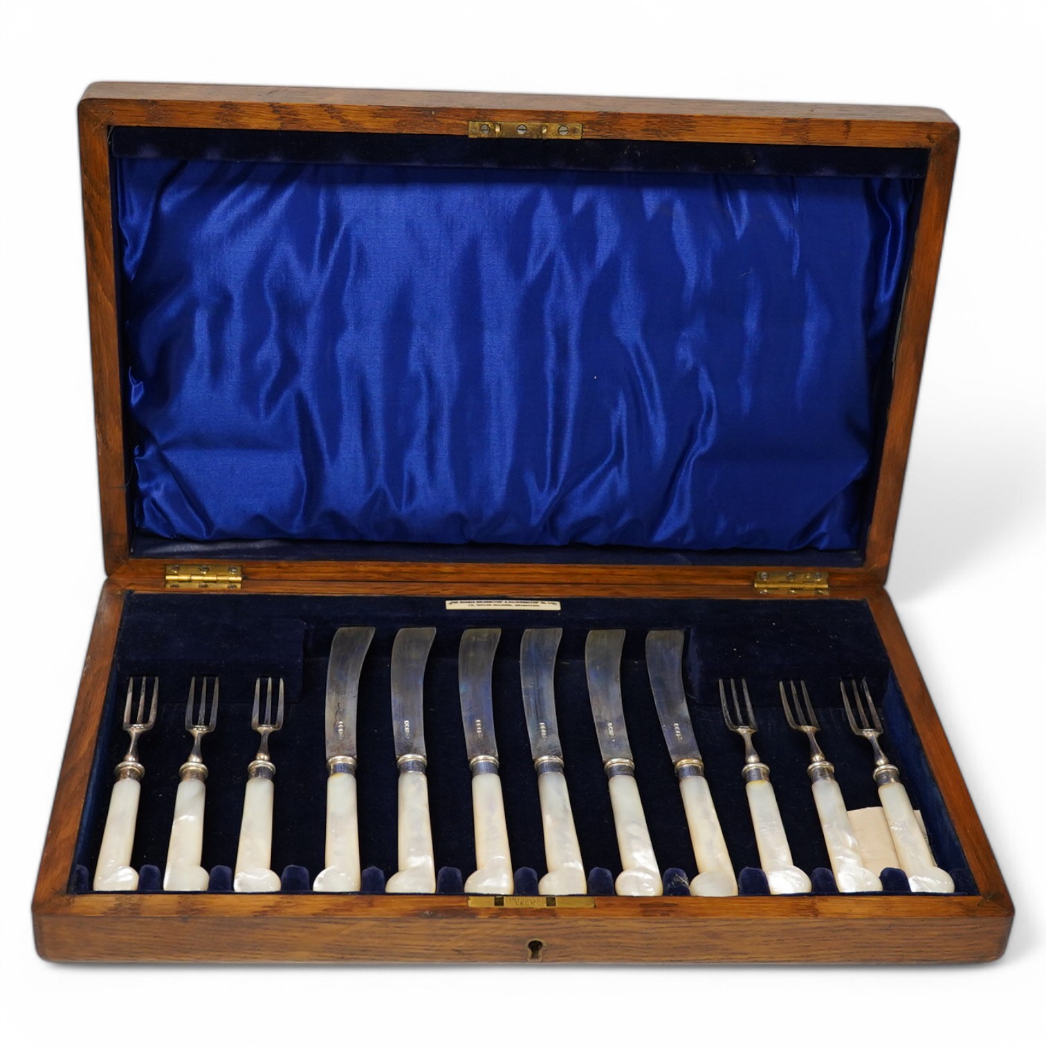 A cased set of six pairs of late Victorian mother of pearl pistol handled silver dessert eaters, by James Dixon & Sons, Sheffield, 1896, knife 20.3cm. Condition - fair to good